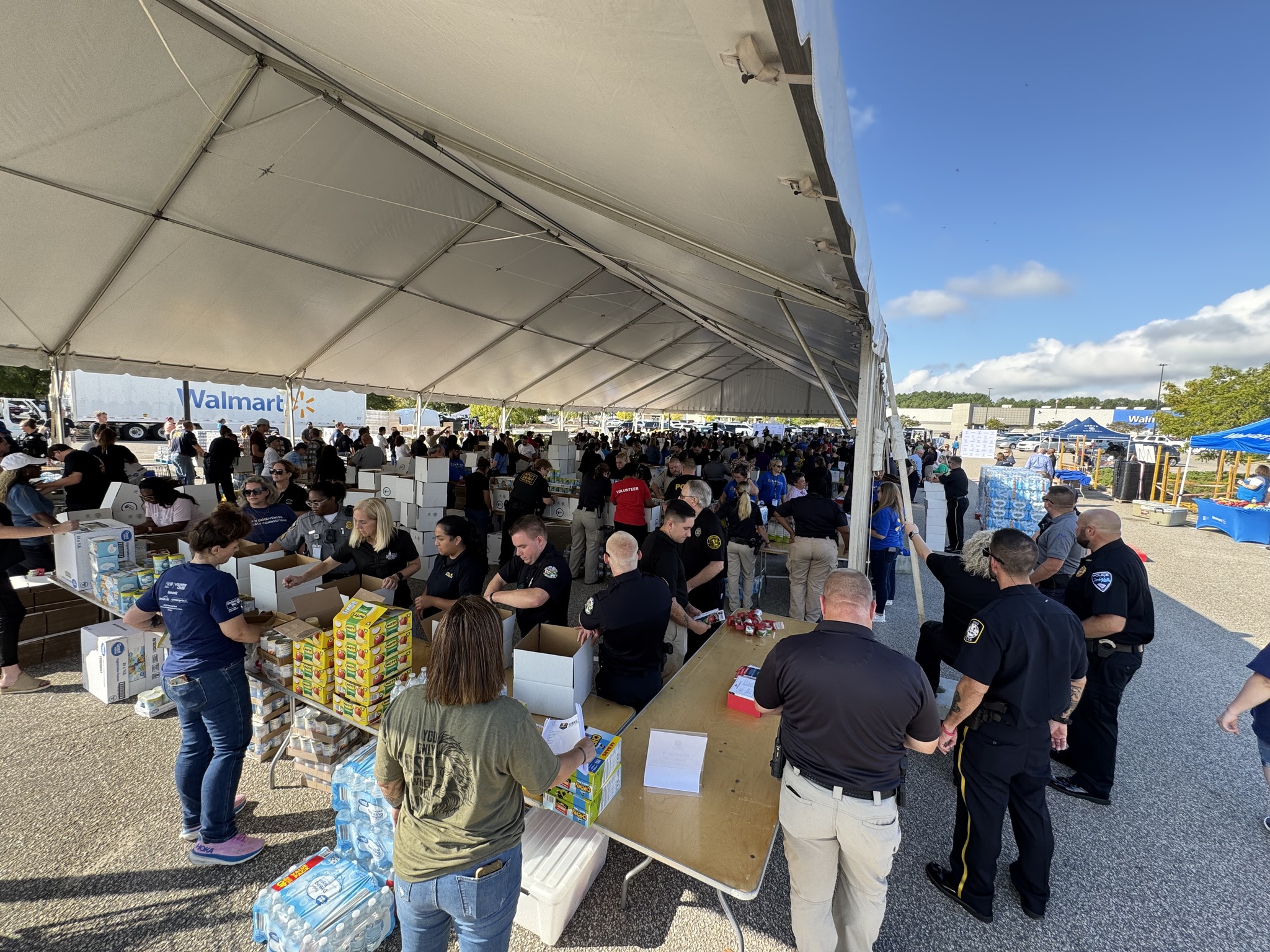 Hundreds of people packing boxes of food for hurricane survivors